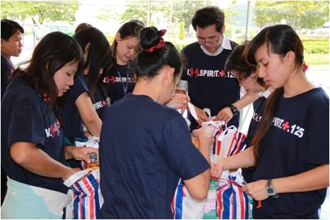 Employees at a Johnson & Johnson operating company in Thailand celebrate the Company's 125th anniversary in 2011 by packing disaster relief supplies to help families in the community.